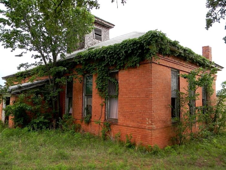 Color image of overgrown schoolhouse, Fallis, Oklahoma.